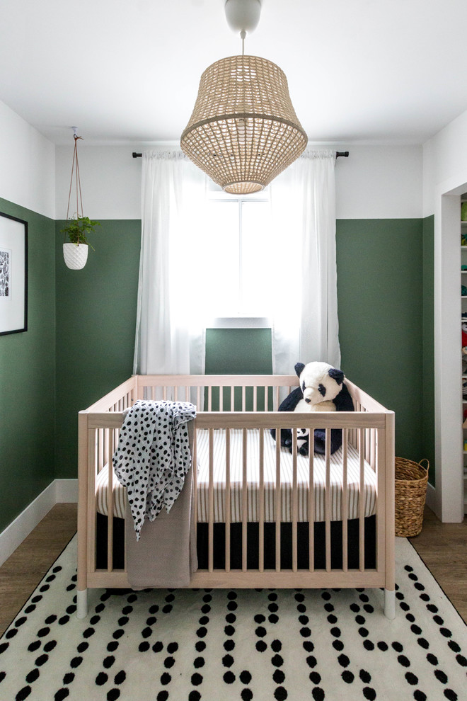 Design ideas for a small modern gender-neutral nursery in Calgary with green walls, vinyl floors and brown floor.