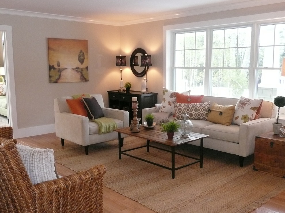 This is an example of a mid-sized transitional open concept living room in Boston with beige walls, light hardwood floors, no fireplace and no tv.
