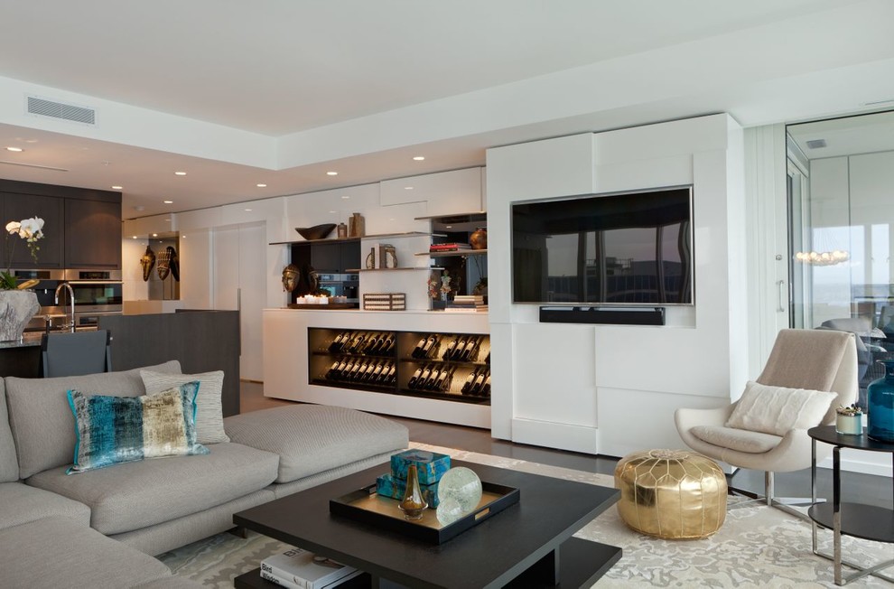 Inspiration for a large contemporary open concept living room in Vancouver with white walls, dark hardwood floors, no fireplace, a wall-mounted tv, brown floor and a home bar.