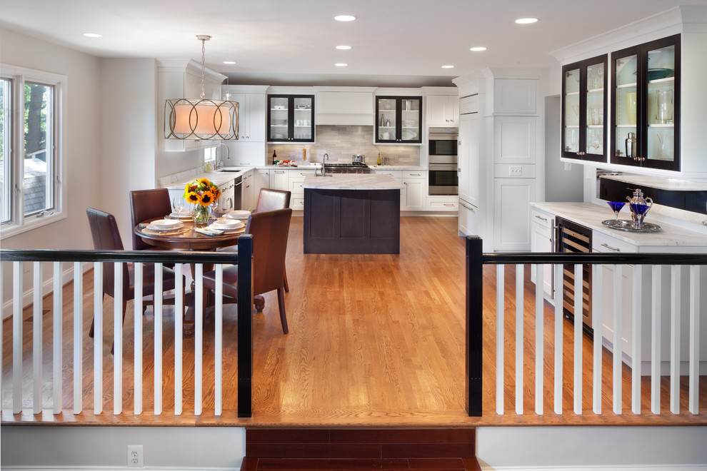 Inspiration for a transitional kitchen/dining combo in DC Metro with white walls and medium hardwood floors.