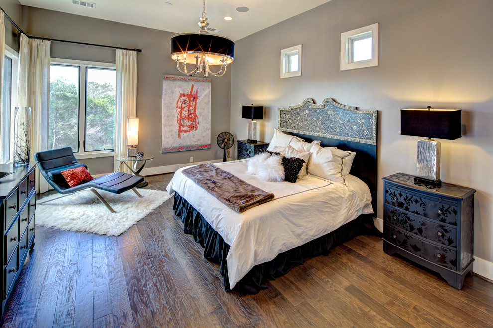 Design ideas for a large contemporary master bedroom in Austin with grey walls and medium hardwood floors.