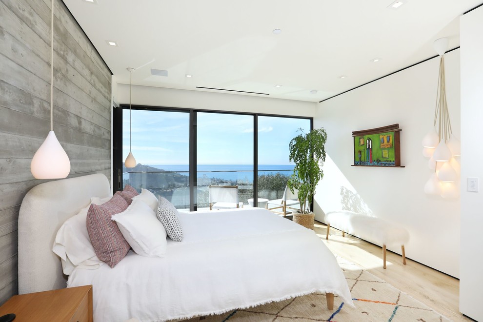 Contemporary bedroom in Orange County with white walls, light hardwood floors and beige floor.
