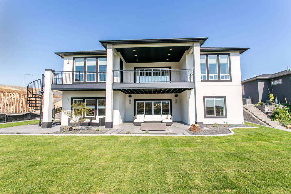 Large trendy backyard deck photo in Seattle with a roof extension