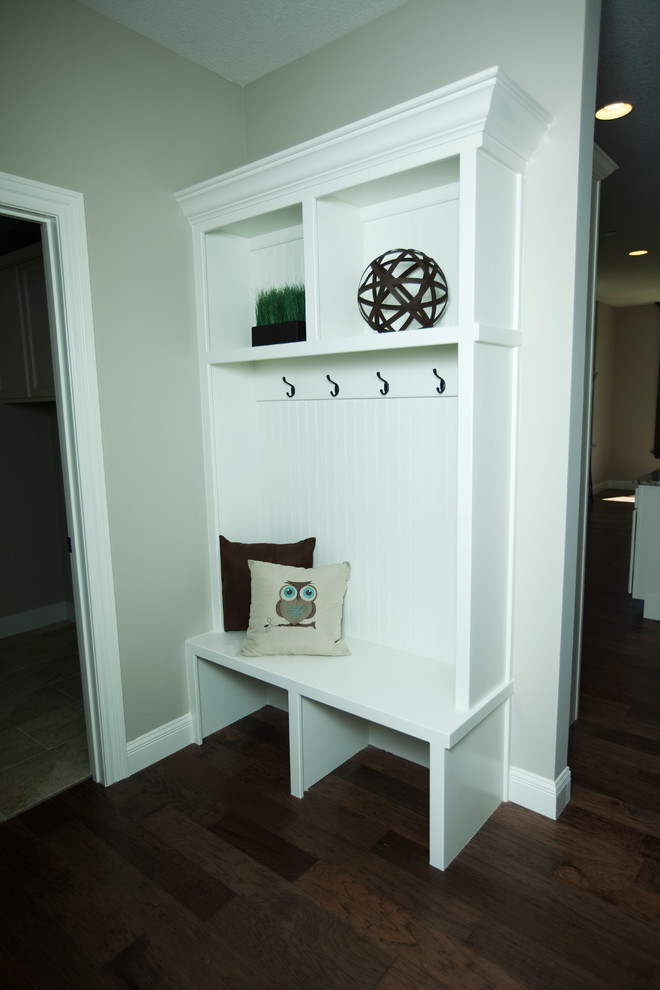 Design ideas for a small transitional mudroom in Other with beige walls and medium hardwood floors.
