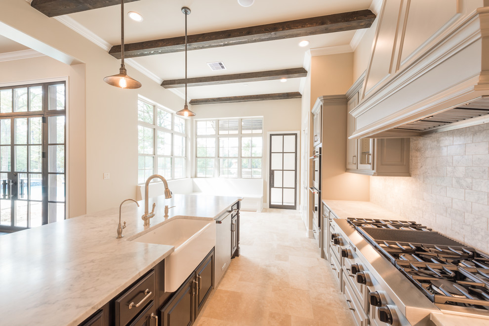 Inspiration for a huge transitional l-shaped porcelain tile and beige floor open concept kitchen remodel in Houston with a farmhouse sink, raised-panel cabinets, gray cabinets, marble countertops, gray backsplash, subway tile backsplash, stainless steel appliances, an island and white countertops