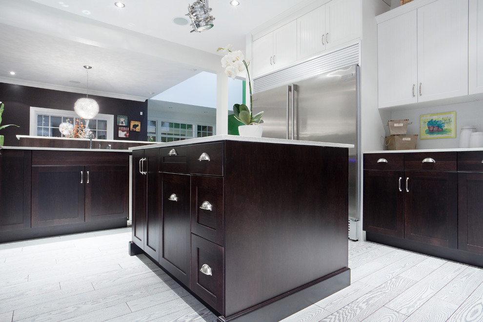 Mid-sized contemporary l-shaped eat-in kitchen in Edmonton with recessed-panel cabinets, dark wood cabinets, quartz benchtops, grey splashback, brick splashback, stainless steel appliances, medium hardwood floors and with island.