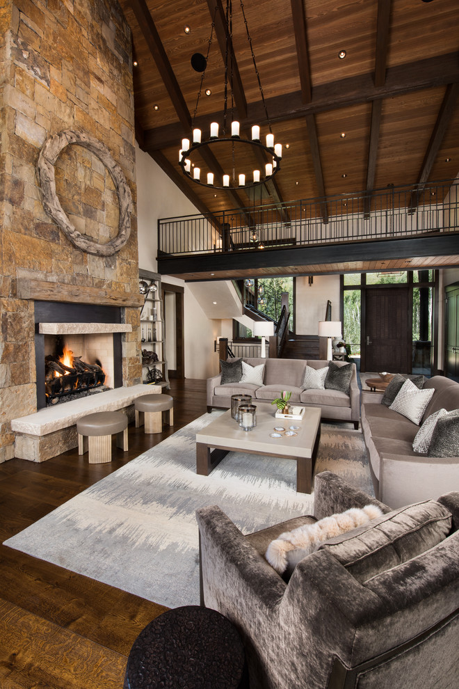 Large country formal open concept living room in Denver with beige walls, a standard fireplace, a stone fireplace surround and dark hardwood floors.