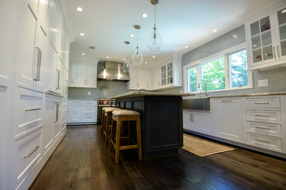Example of a large transitional u-shaped medium tone wood floor and brown floor eat-in kitchen design in DC Metro with a farmhouse sink, recessed-panel cabinets, white cabinets, marble countertops, stainless steel appliances, an island, gray backsplash and porcelain backsplash