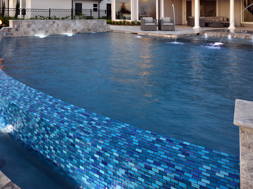 Huge transitional backyard stone and custom-shaped infinity hot tub photo in Houston