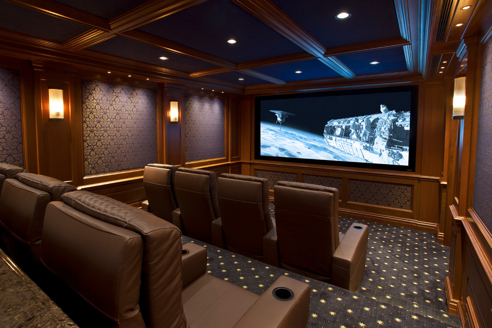 This is an example of a small traditional enclosed home theatre in New York with blue walls, carpet and a projector screen.