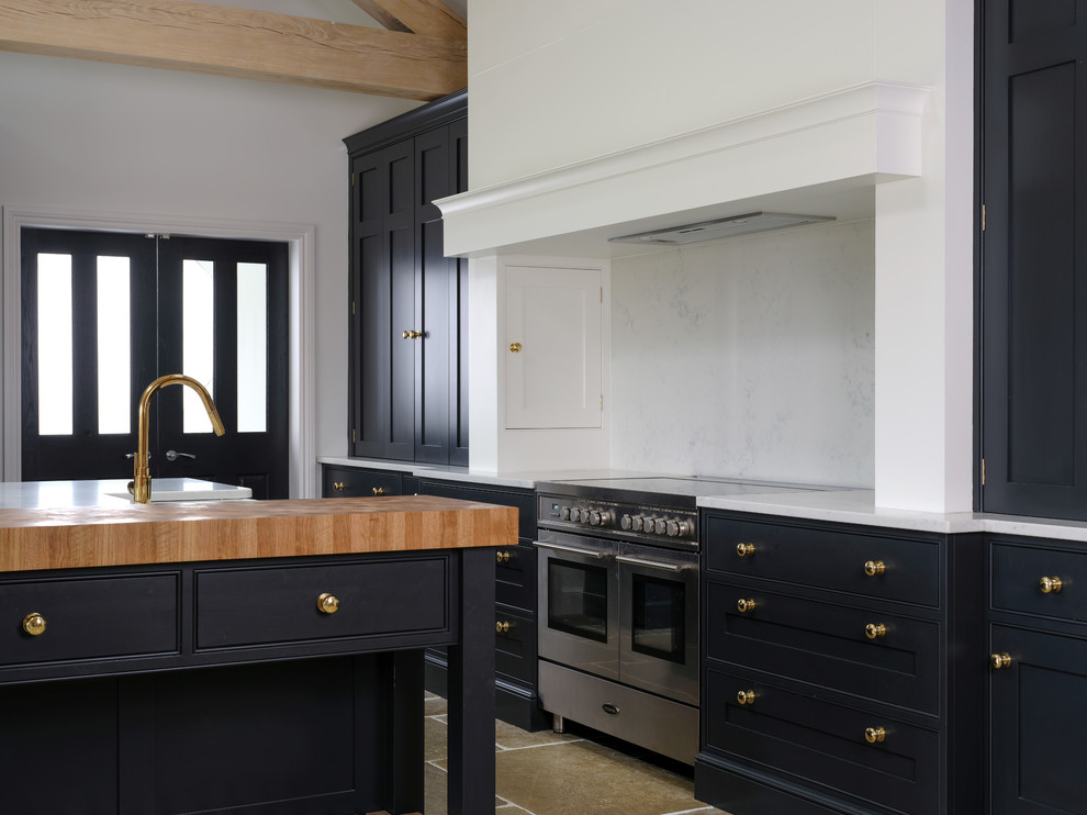 Photo of a transitional kitchen in Cheshire with a farmhouse sink, black cabinets, quartzite benchtops, with island and white benchtop.
