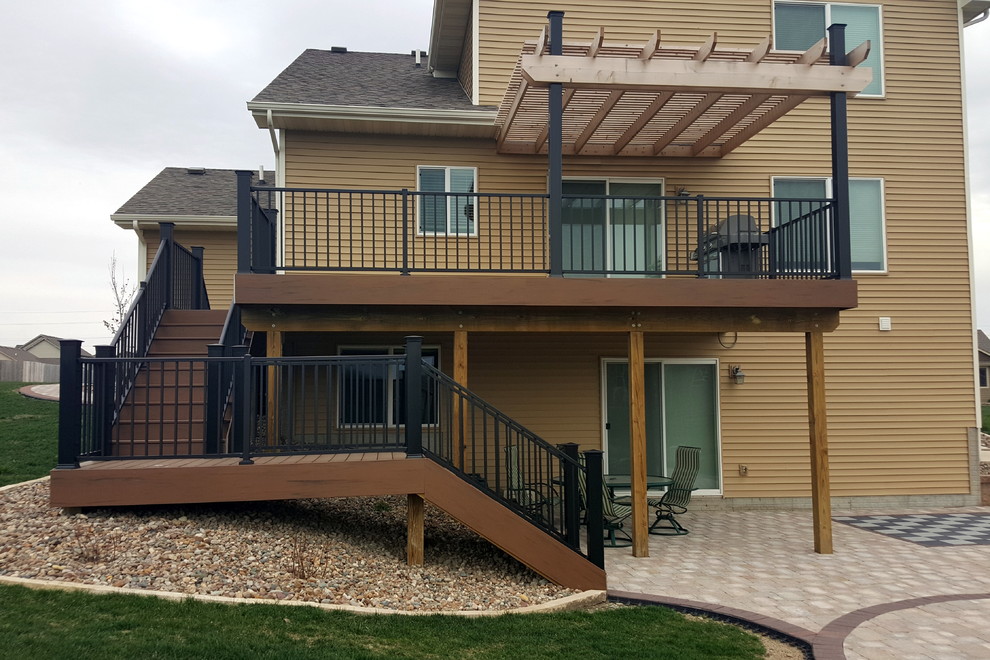 Inspiration for a large backyard deck remodel with a pergola
