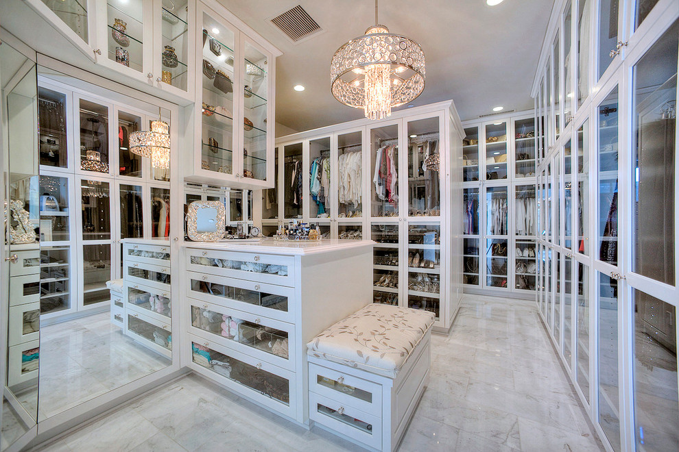 Design ideas for a traditional gender-neutral dressing room in Phoenix with glass-front cabinets and white cabinets.