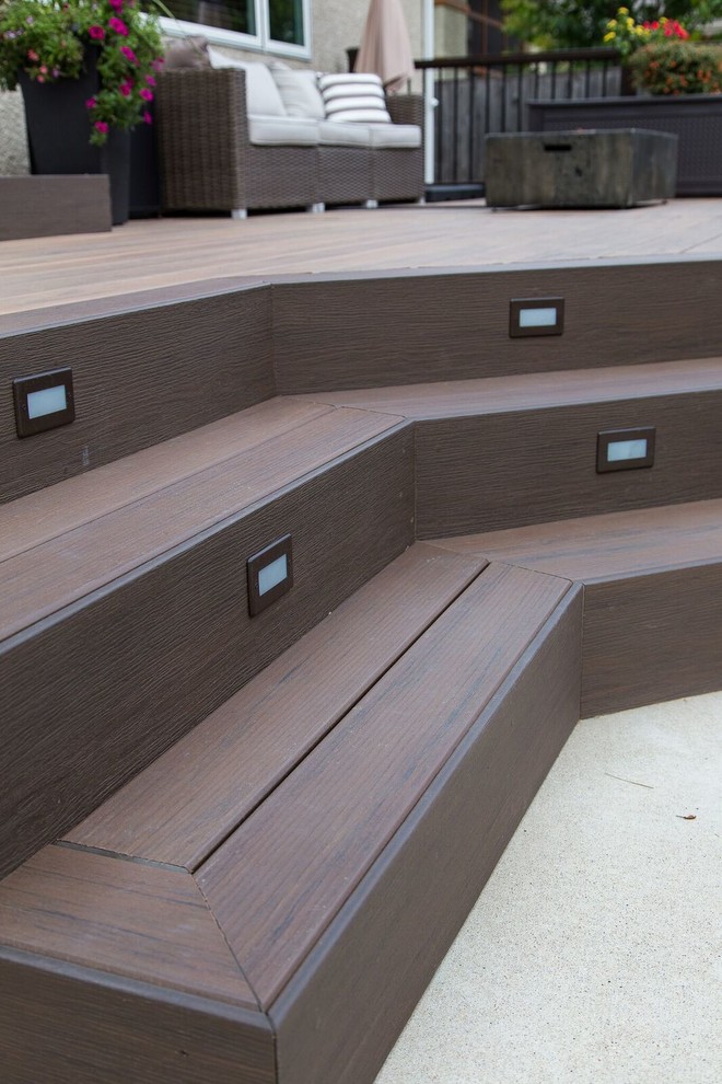 Deck - mid-sized transitional backyard deck idea with no cover