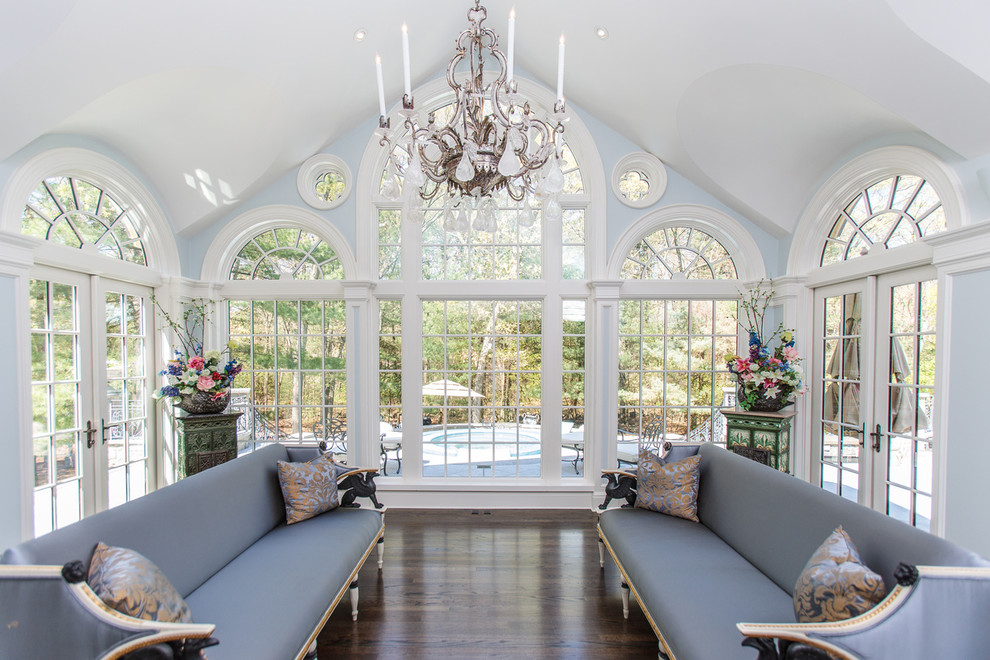 Design ideas for a traditional sunroom in Boston with dark hardwood floors, a standard ceiling and brown floor.