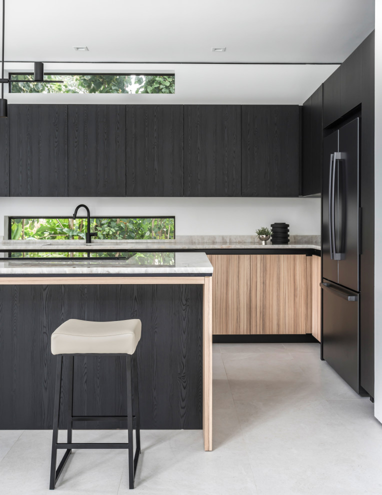 Design ideas for a mid-sized contemporary u-shaped eat-in kitchen in Miami with a single-bowl sink, flat-panel cabinets, black cabinets, onyx benchtops, beige splashback, marble splashback, black appliances, ceramic floors, with island, grey floor and beige benchtop.