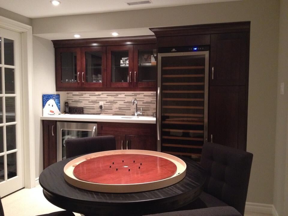 Mid-sized transitional single-wall beige floor wet bar photo in Toronto with an undermount sink, glass-front cabinets, dark wood cabinets, multicolored backsplash and matchstick tile backsplash