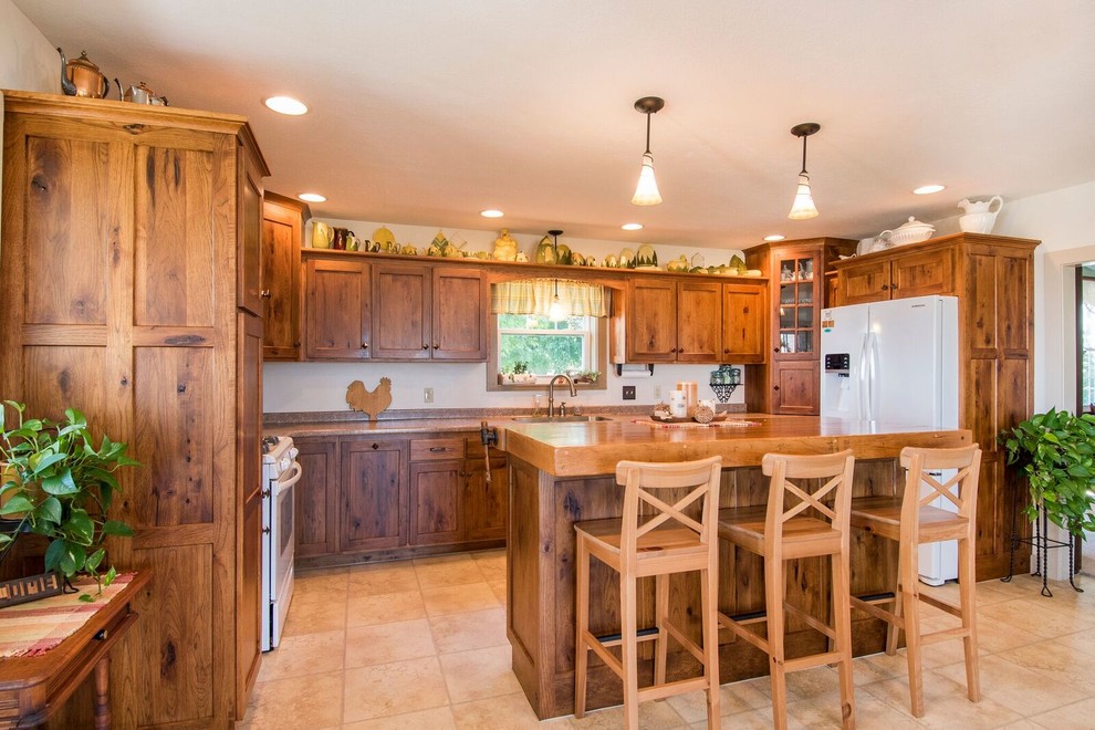 Mid-sized mountain style u-shaped laminate floor and beige floor eat-in kitchen photo in Cincinnati with a drop-in sink, recessed-panel cabinets, medium tone wood cabinets, wood countertops, white appliances, an island and brown countertops