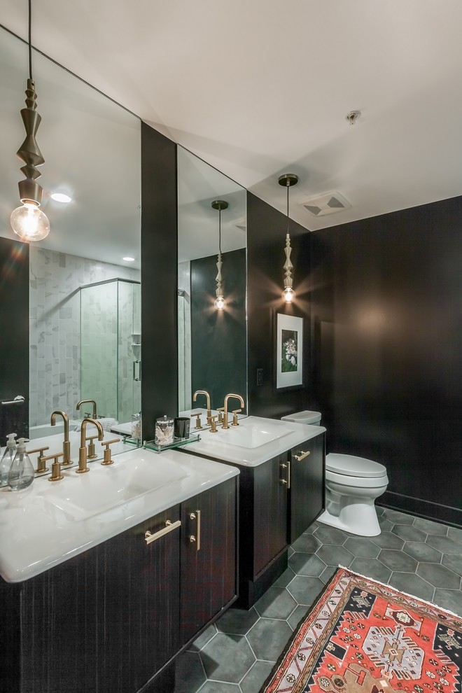 Inspiration for a small contemporary master bathroom in Omaha with flat-panel cabinets, dark wood cabinets, black walls, dark hardwood floors, an integrated sink, a drop-in tub, a corner shower, gray tile and stone tile.