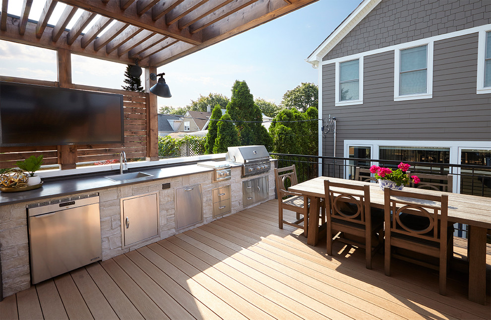 Design ideas for a mid-sized arts and crafts rooftop deck in Chicago with an outdoor kitchen and a pergola.