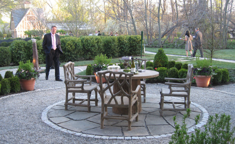 Inspiration for a small traditional side yard patio in New York with natural stone pavers and an awning.