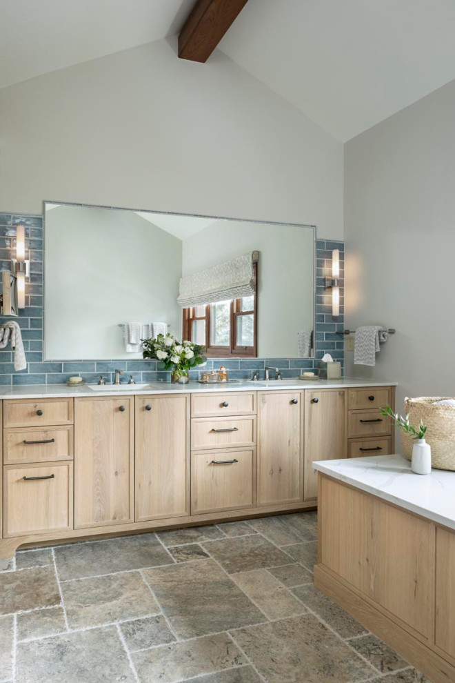 Large transitional master bathroom in Denver with furniture-like cabinets, light wood cabinets, an undermount tub, a one-piece toilet, blue tile, subway tile, grey walls, travertine floors, an undermount sink, engineered quartz benchtops, grey floor, white benchtops, a double vanity, a built-in vanity and vaulted.