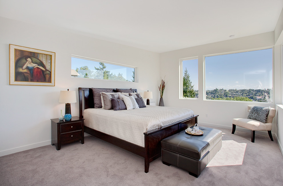 Inspiration for a transitional bedroom in Seattle with white walls and carpet.