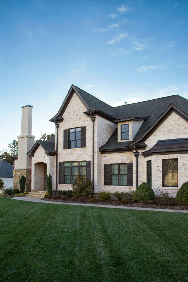 Design ideas for a mid-sized traditional two-storey brick white exterior in Other.