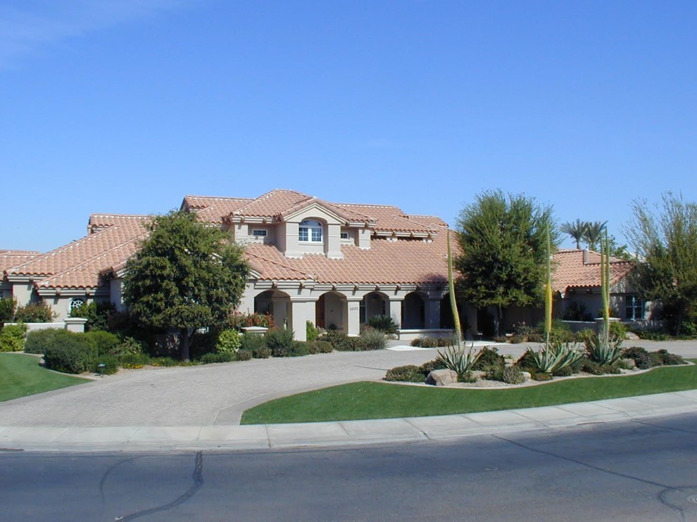 Design ideas for a large mediterranean two-storey stucco beige exterior in Phoenix with a hip roof.