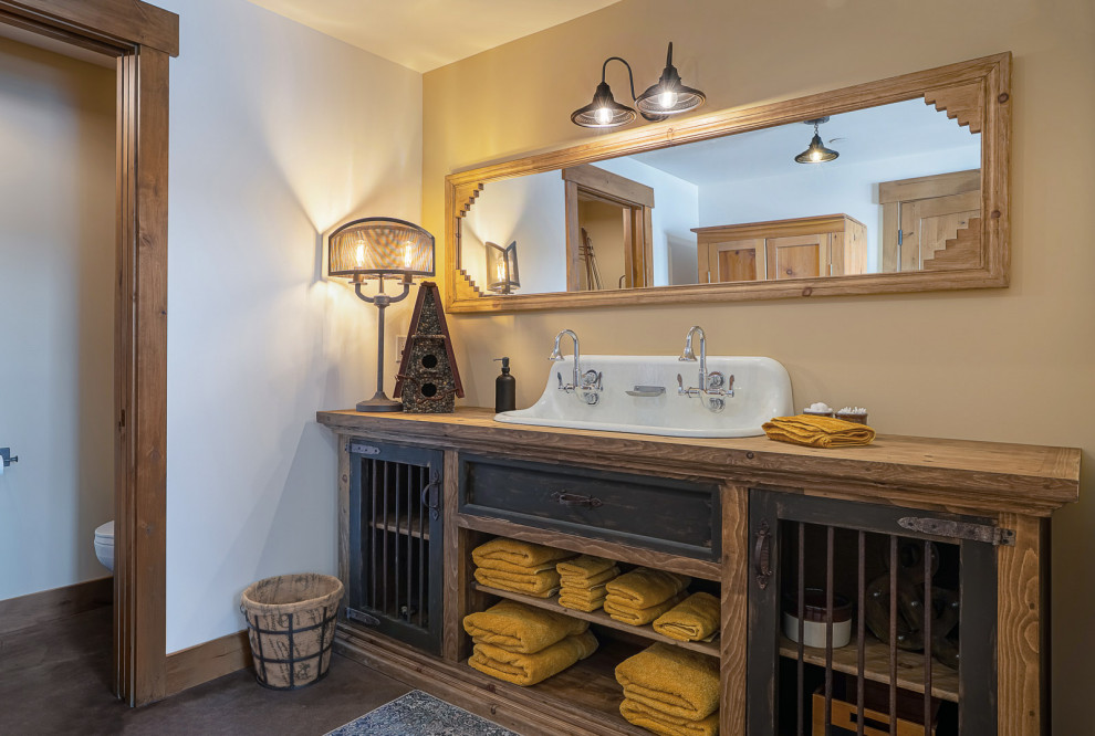 Mid-sized mountain style master porcelain tile, brown floor, double-sink and vaulted ceiling freestanding bathtub photo in Seattle with shaker cabinets, medium tone wood cabinets, a one-piece toilet, white walls, a drop-in sink, wood countertops, a hinged shower door, brown countertops and a built-in vanity