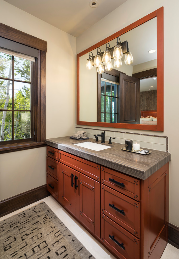 Inspiration for an expansive country bathroom in Salt Lake City with marble benchtops, recessed-panel cabinets, brown cabinets, subway tile, white walls, an undermount sink, beige floor and grey benchtops.
