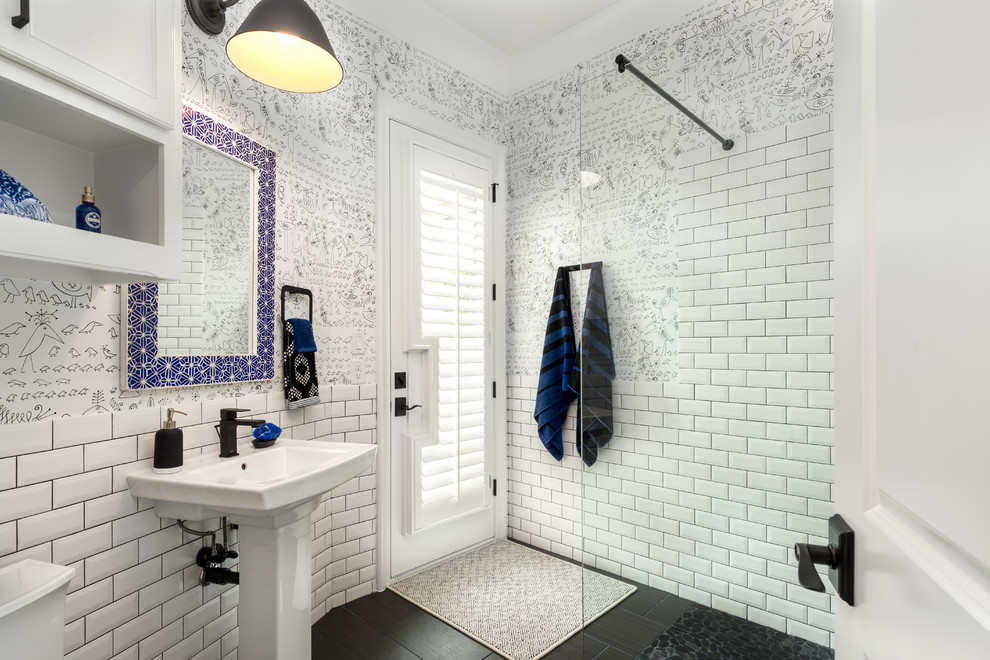 Photo of a transitional 3/4 bathroom in Dallas with shaker cabinets, white cabinets, an open shower, a one-piece toilet, white tile, subway tile, beige walls, porcelain floors, a pedestal sink, black floor and an open shower.
