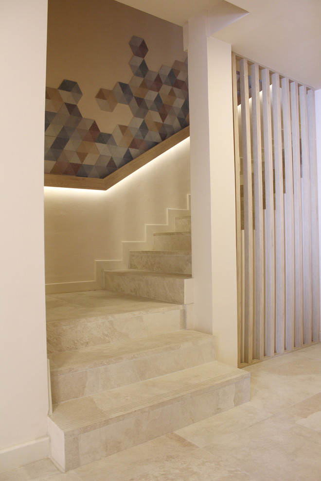 Small contemporary tile staircase in Other with tile risers and wood railing.