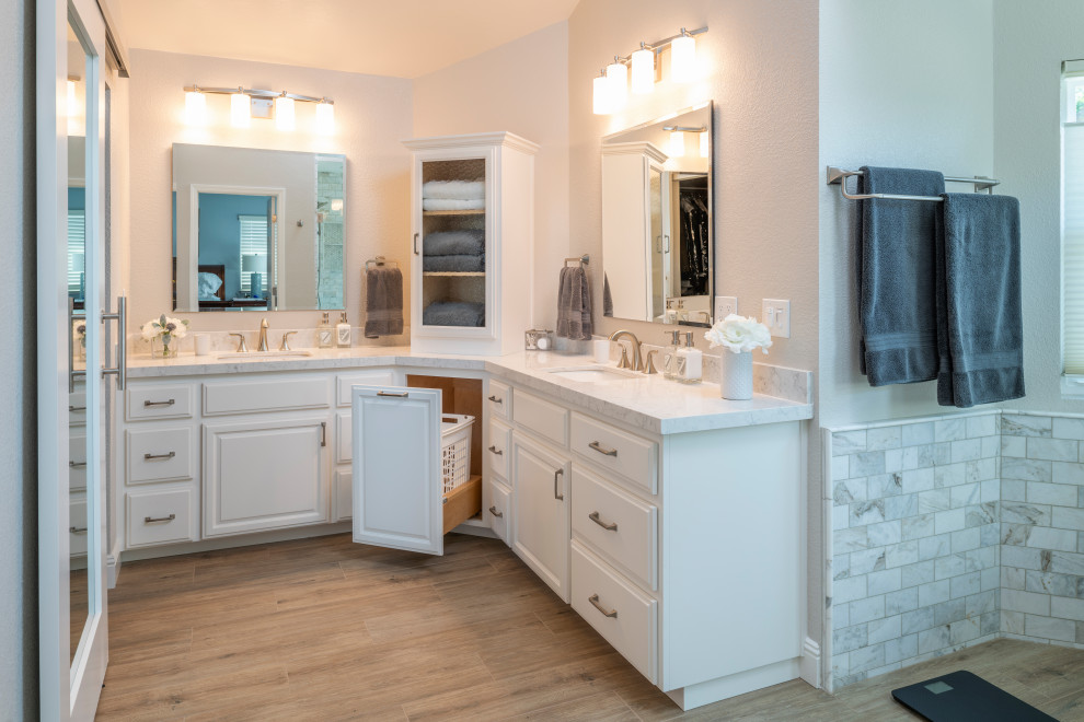 Inspiration for a contemporary master bathroom in San Francisco with white cabinets, a freestanding tub, a corner shower, gray tile, marble, beige walls, porcelain floors, an undermount sink, engineered quartz benchtops, brown floor, a hinged shower door, white benchtops, a double vanity and a built-in vanity.