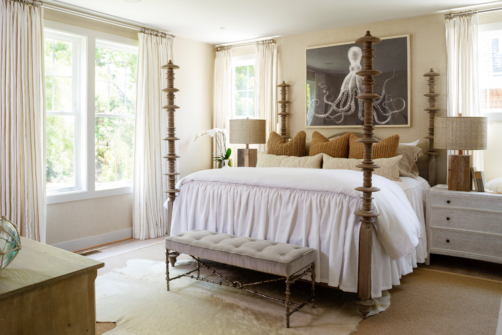 Design ideas for a beach style master bedroom in DC Metro with beige walls, medium hardwood floors and beige floor.