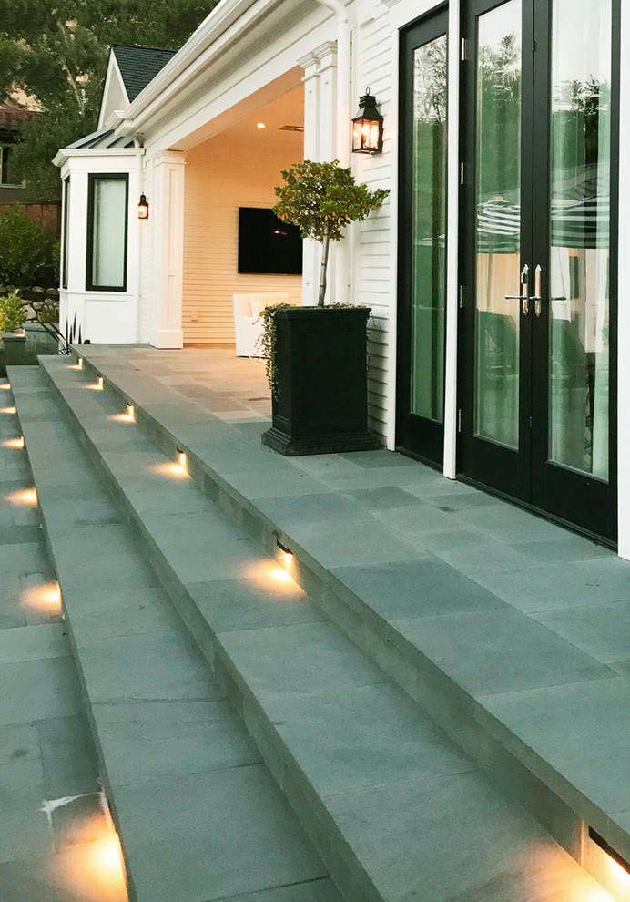 This is an example of a large transitional front yard patio in San Francisco with natural stone pavers.