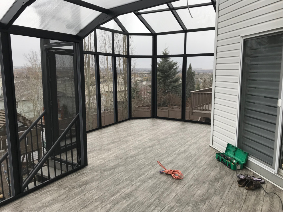 Inspiration for a mid-sized rustic backyard privacy deck remodel in Calgary with a pergola