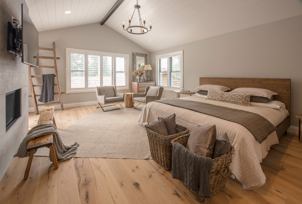 Design ideas for a country bedroom in Seattle with light hardwood floors.