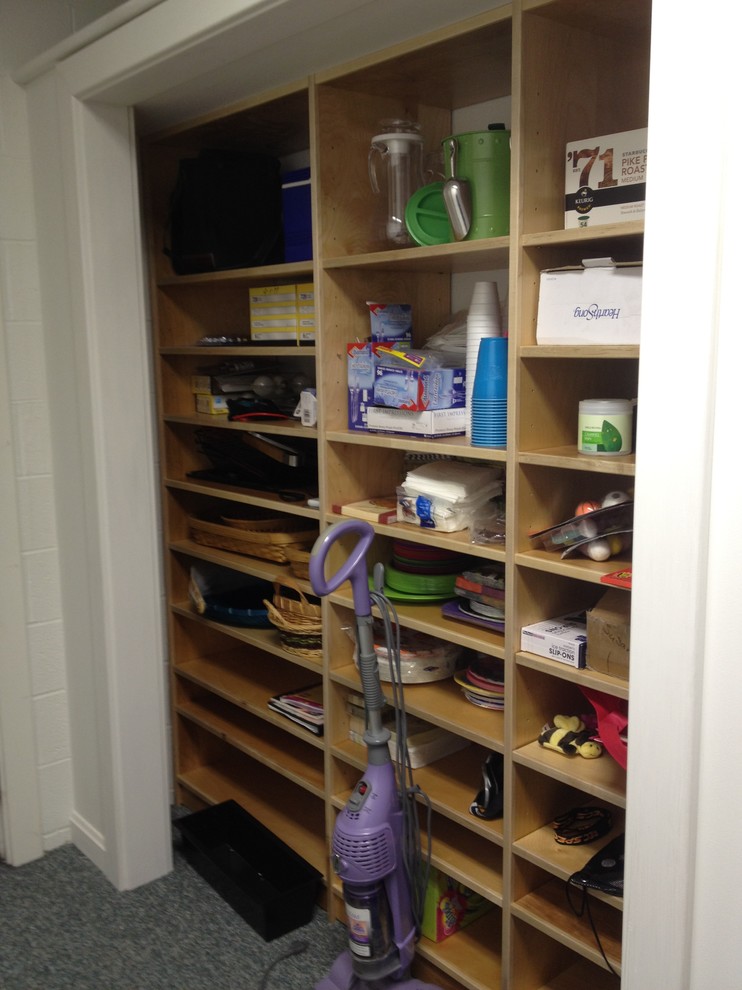 Walk-in closet - mid-sized transitional carpeted walk-in closet idea with open cabinets and light wood cabinets