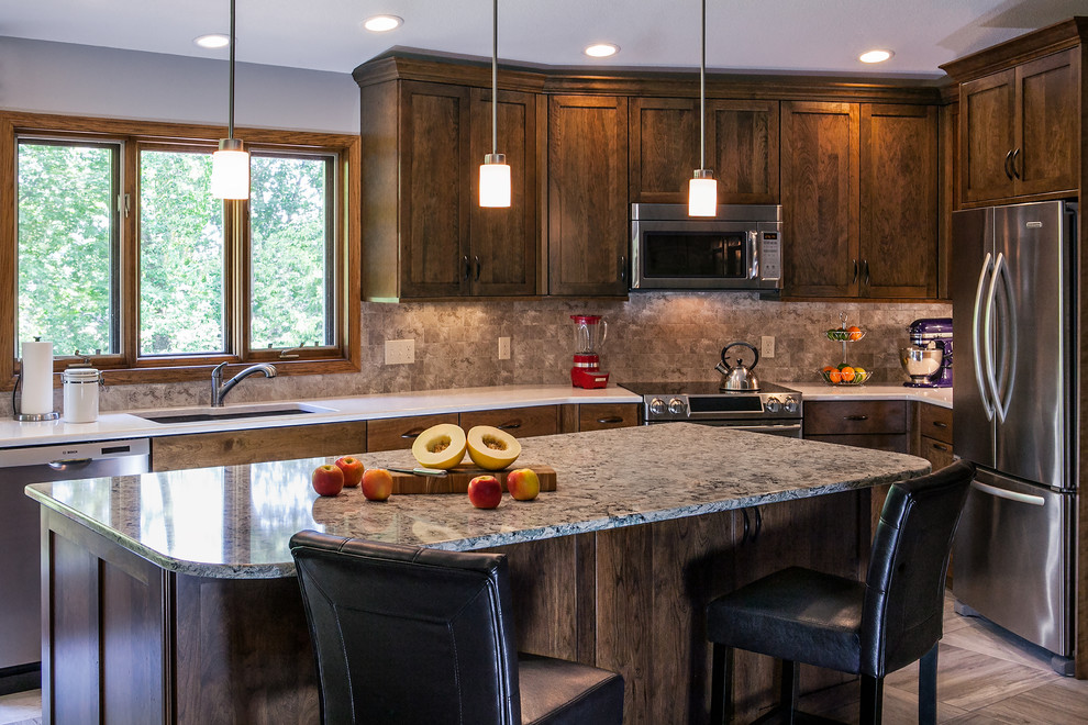 Inspiration for a large timeless l-shaped ceramic tile open concept kitchen remodel with an undermount sink, flat-panel cabinets, medium tone wood cabinets, quartzite countertops, brown backsplash, ceramic backsplash, stainless steel appliances and an island