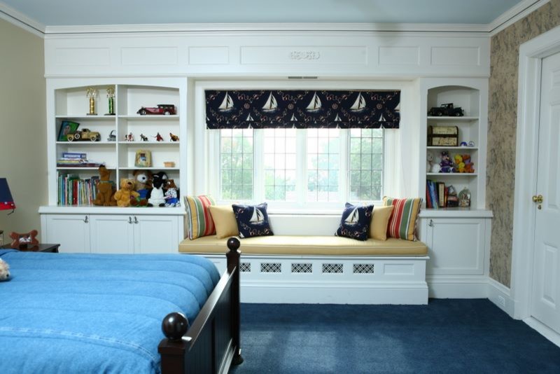 This is an example of a mid-sized traditional kids' bedroom for kids 4-10 years old and boys in New York with carpet, black walls and blue floor.