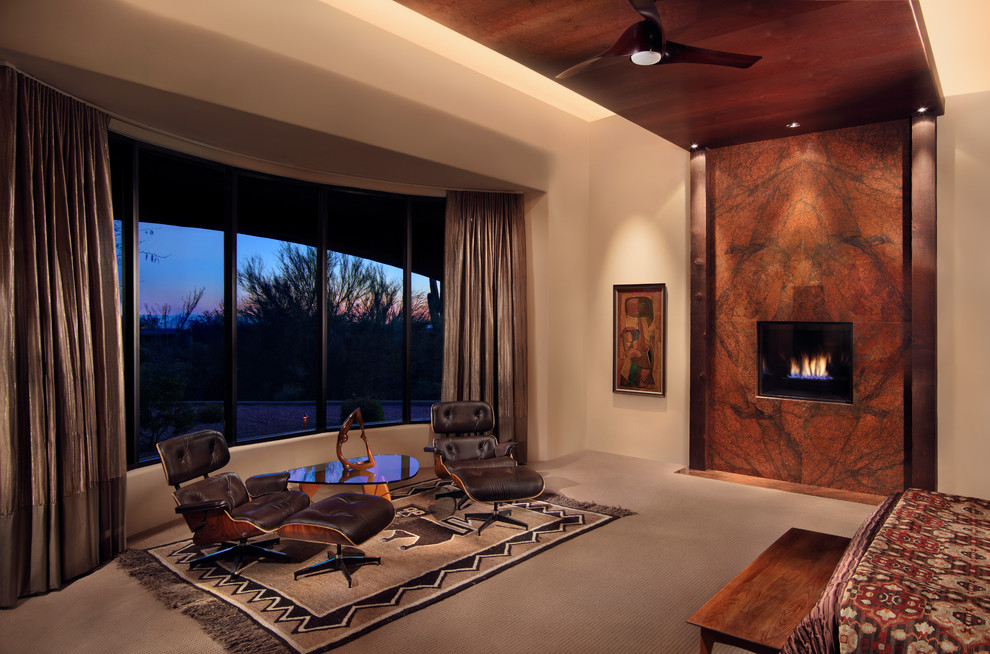 Photo of a large contemporary master bedroom in Phoenix with white walls, carpet, a standard fireplace and a stone fireplace surround.