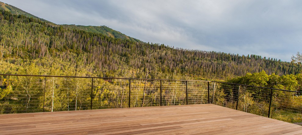 Example of a large transitional backyard balcony deck design in Denver with no cover