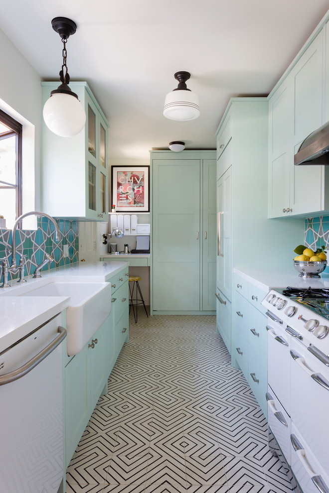 Photo of a small eclectic galley kitchen in Los Angeles with shaker cabinets, no island, a farmhouse sink, green cabinets, multi-coloured splashback, white appliances, multi-coloured floor, white benchtop and cement tiles.