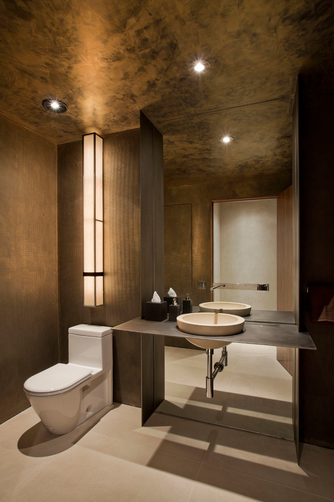 Contemporary powder room in New York with a vessel sink, a one-piece toilet and brown walls.