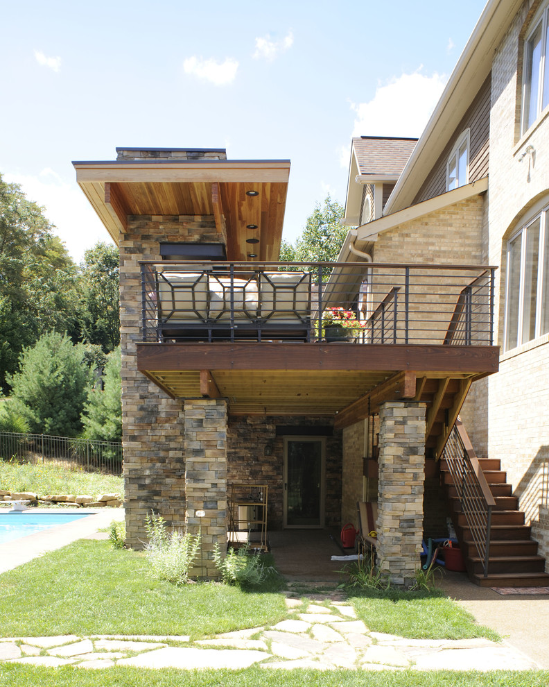 Photo of a mid-sized contemporary backyard deck in Other with an outdoor kitchen and a roof extension.