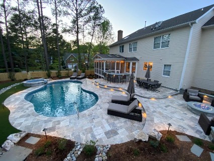 Example of a large transitional backyard stone and kidney-shaped natural pool landscaping design in Raleigh