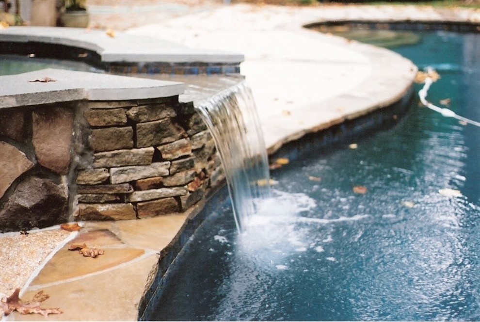 Mid-sized backyard stone and custom-shaped lap hot tub photo in Baltimore