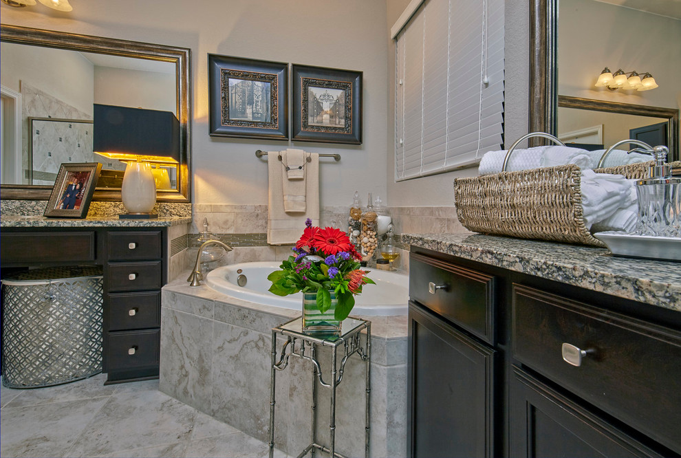 Large traditional master bathroom in San Diego with shaker cabinets, brown cabinets, a freestanding tub, a corner shower, beige tile, black and white tile, beige walls, marble floors, an undermount sink and granite benchtops.