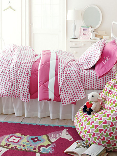 Inspiration for a contemporary kids' bedroom for girls in Burlington with white walls and light hardwood floors.
